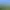 Vaste paysage de collines verdoyantes sous un ciel bleu parsemé de nuages